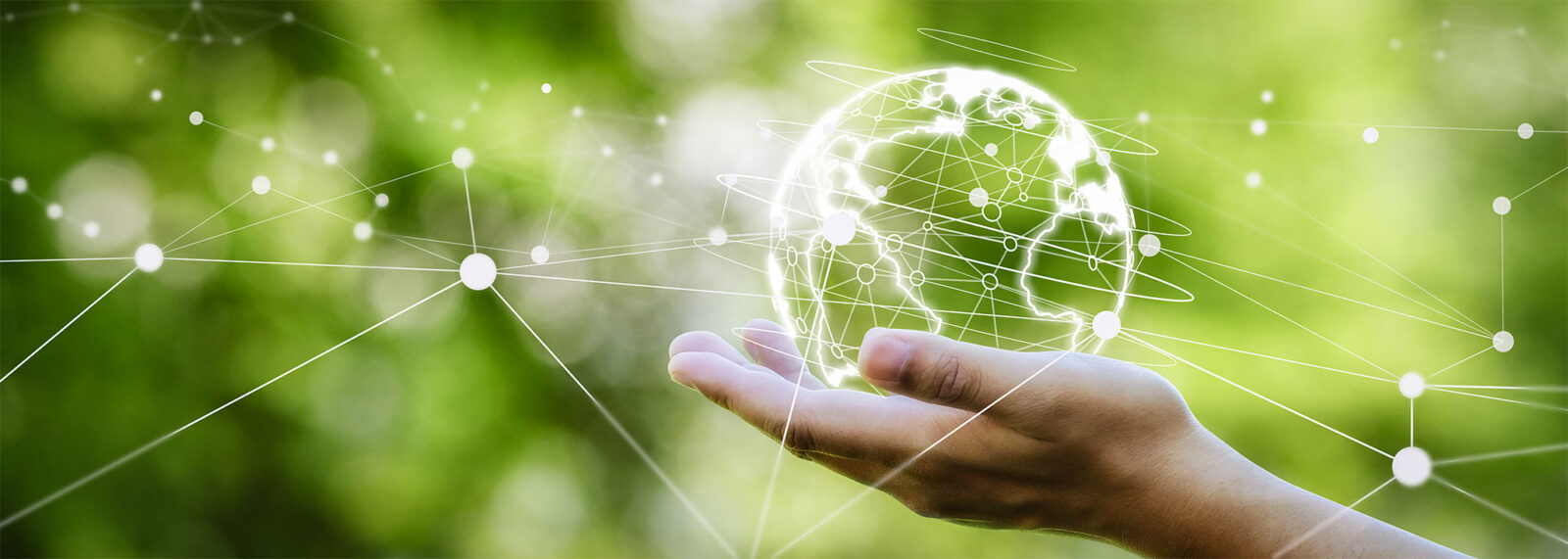 A hand holding a digitally networked globe against a green background, symbolizing CLiQ SwissTech's global commitment to sustainability and a carbon-neutral future.